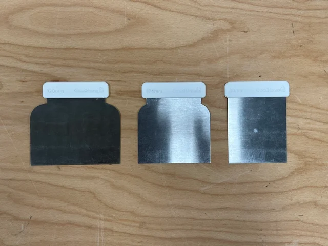 Three continental filling knives with short grips and wide steel blades